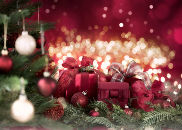 istock Christmas Gifts on a Red Bokeh Background 1349860048
