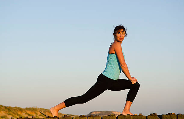 istock woman exercising on the beach. 134986028