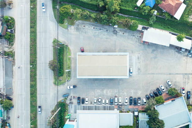 Gas or filling station building in aerial view. May call petrol pump. Include car park, road, mart or store. To service by refueling energy, oil, gasoline, diesel for car, auto. Transport industry.