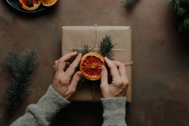 istock Female hands decorates Christmas present 1349862617