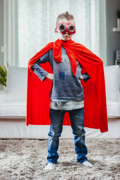 istock Determined young Super Hero in a colorful red cape 1349877090