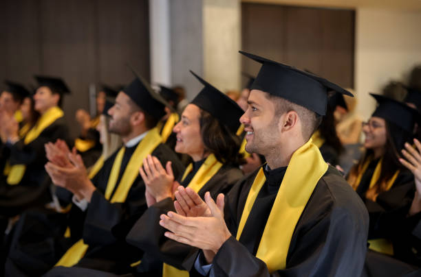 istock Graduate students clapping in their graduation ceremony 1349878785