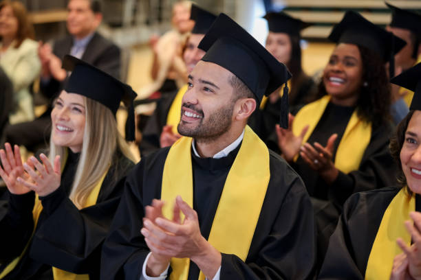 istock Happy graduate student clapping in his graduation ceremony 1349878788