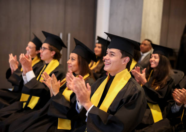 istock Happy graduates applauding in their graduation ceremony 1349878790