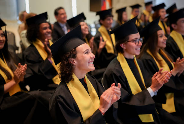 istock Happy graduates applauding in their graduation ceremony after the commencement speech 1349878802