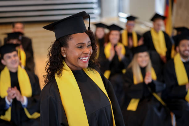 istock Happy graduating student walking to the front to get her diploma 1349878816