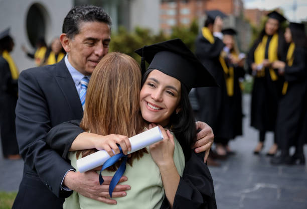 istock Happy graduate student hugging her mother on graduation day 1349878839
