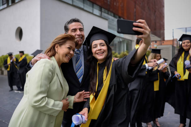 istock Graduate student taking a selfie with her parents on her graduation day 1349878841