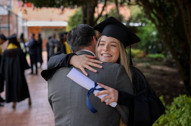 istock Happy graduate student hugging her father on graduation day 1349878856