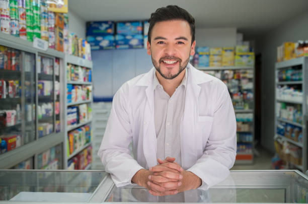 istock Latin American male pharmacist leaning on counter while facing camera very happy and smiling 1349881299
