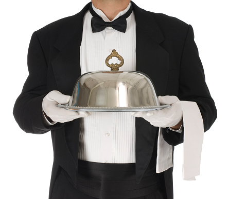 Waiter torso holding a silver tray with catering dome on a white background