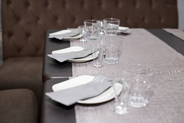 istock A table set in a restaurant plates, glasses, napkins 1349891610