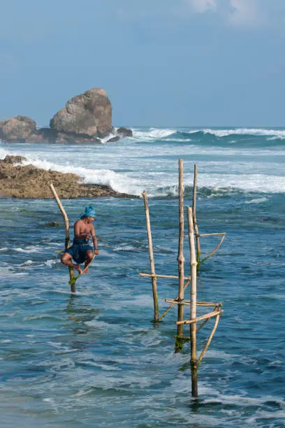 Stilt fisherman fishing in the ocean, Koggala, Sri Lanka, Indian Ocean, Asia