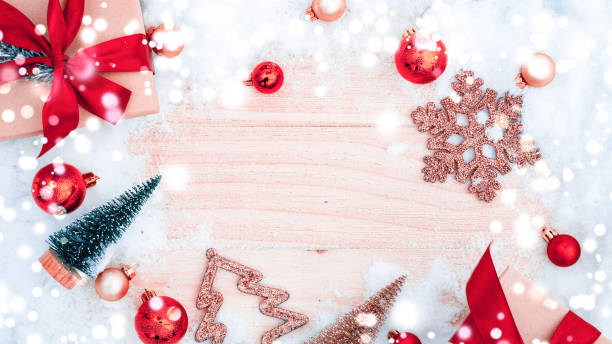 istock Xmas background table. Winter wooden decoration backdrop. Christmas board with old rustic wall, white frozen snow, golden balls and gift box. Minimal flat lay. 1349901467