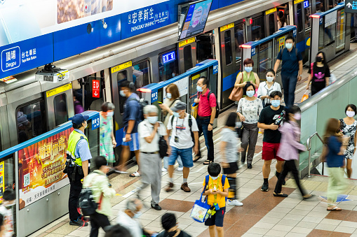 Taipei, Taiwan- August 27, 2021: Commuters are shuttled inside the Zhongxiao Xinsheng Station of the Taipei MRT in Taiwan. This is the time when the traffic is heavy