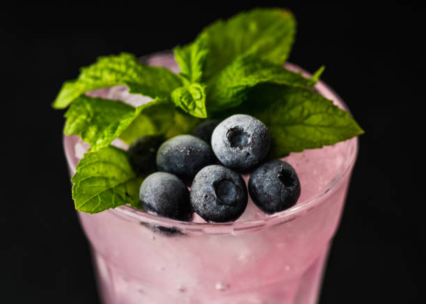 istock Gin based pink cocktail with blueberry. Selective focus. Shallow depth of field. 1349903556