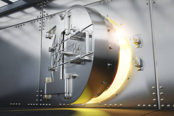 istock Open Bank vault door with gold light comes out from inside 1349905891