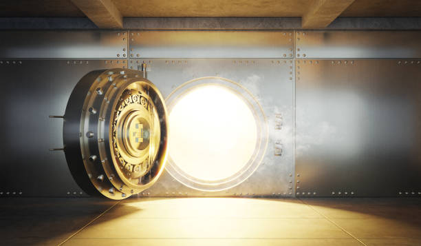 istock Open Bank vault door with gold light comes out from inside 1349905973