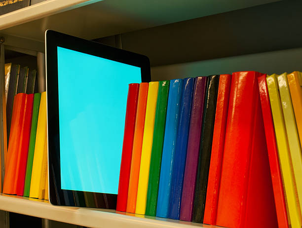 istock Row of colorful books and e-book reader on the shelf 134990792