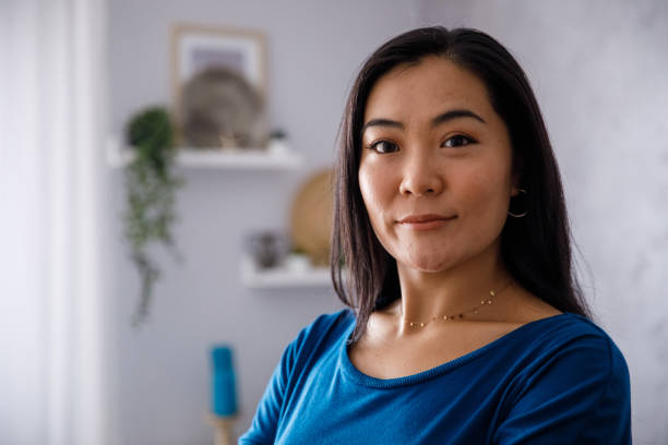 istock Young woman looking at camera and smiling slightly 1349909041