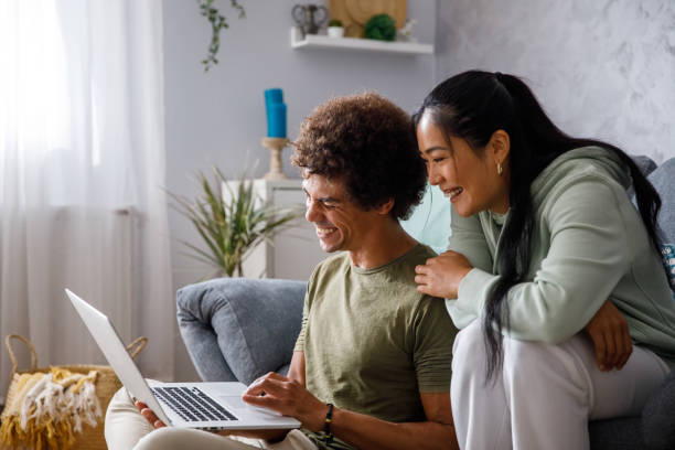 istock Cheerful couple looking at something on laptop, laughing 1349910504