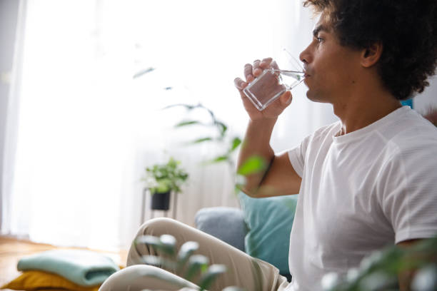 istock Side view of young man drinking water 1349910723