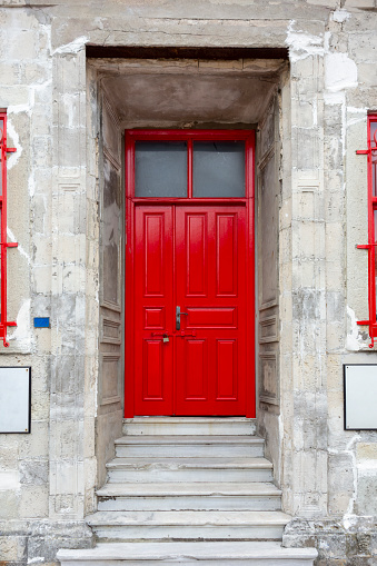 Entrance to ornate red door of historic building