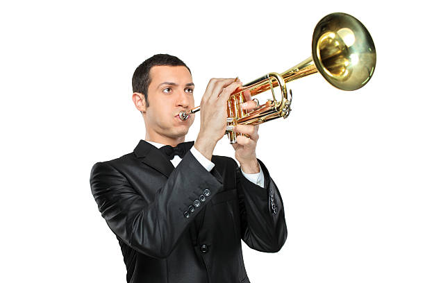 istock Young man in suit playing a trumpet 134991159