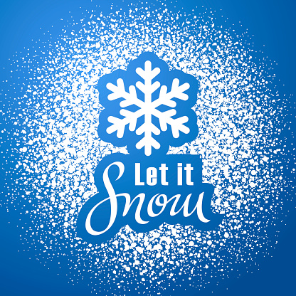 Greeting the winter with powdered sugar spraying the shape of snowflake and Let it Snow lettering on the blue background