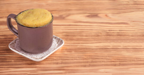 istock vanilla mugcake is microwaved. Homemade cupcake in a coffee mug. 1349913697
