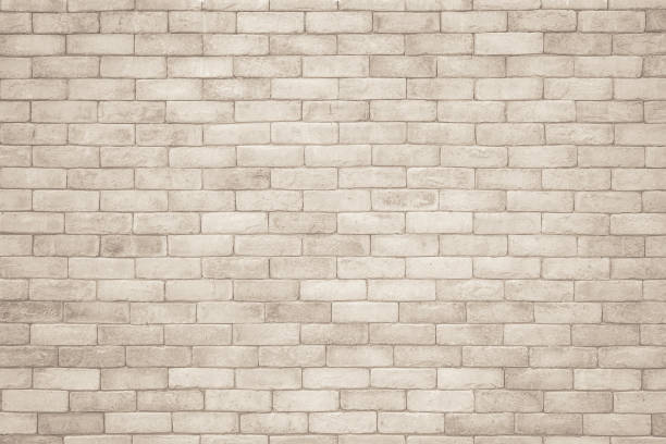 istock Cream and white brick wall texture background. Brickwork and stonework flooring interior rock old pattern clean concrete grid uneven bricks design stack. Background of old vintage brick wall 1349913780