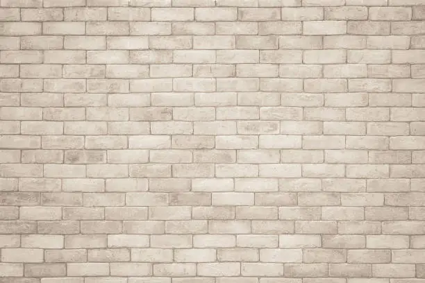 Photo of Cream and white brick wall texture background. Brickwork and stonework flooring interior rock old pattern clean concrete grid uneven bricks design stack. Background of old vintage brick wall
