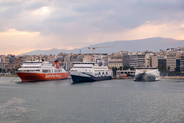 Piraeus, Athens, Greece -09.22.2021: Transportation concept. Greek ferry series. Different cargo and passenger ships. High speed catamaran traveling and connecting Aegean Islands with main land. Nautical background with copy space