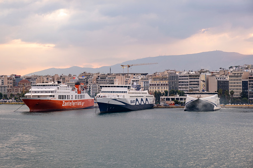 Piraeus, Athens, Greece -09.22.2021: Transportation concept. Greek ferry series. Different cargo and passenger ships. High speed catamaran traveling and connecting Aegean Islands with main land. Nautical background with copy space