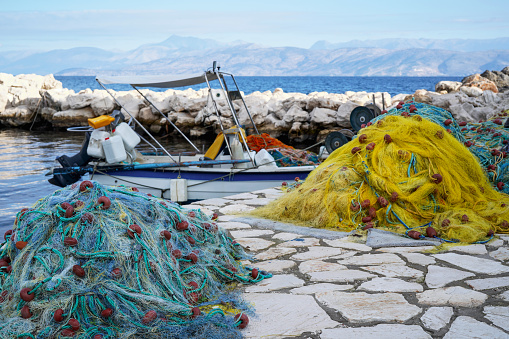 stack of fishing nets and boat in the port