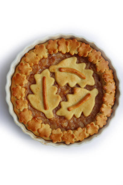 istock Traditional homemade Apple Pie with fall decoration on white 1349915304