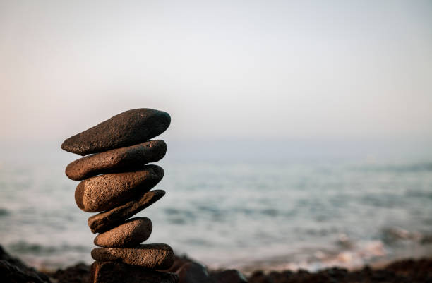 istock Tower of rocks on beach during sunrise 1349916311