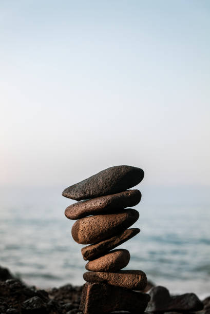 istock Tower of rocks on beach during sunrise 1349916318