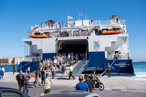 Syros Island, Cyclades, Greece -09.27.2021: Transportation concept. Greek ferry series. Different cargo and passenger ships. High speed catamaran traveling and connecting Aegean Islands with main land. Nautical background with copy space