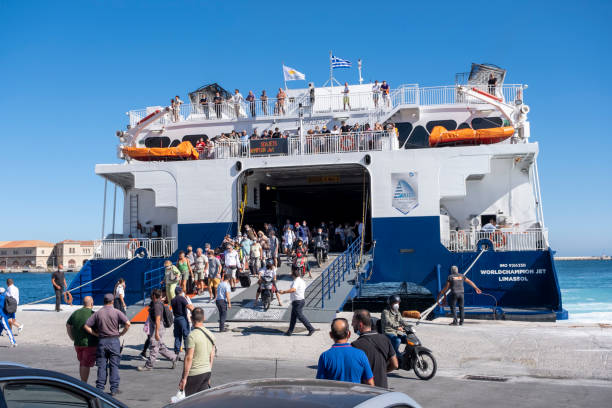 Traveling people disembarking from Greek SEAJETS catamaran and waiting people Syros Island, Cyclades, Greece -09.27.2021: Transportation concept. Greek ferry series. Different cargo and passenger ships. High speed catamaran traveling and connecting Aegean Islands with main land. Nautical background with copy space ferry stock pictures, royalty-free photos & images