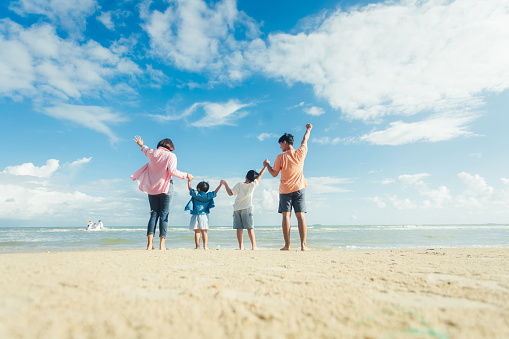 Happy young family Asian have fun on beach. Young family on vacation have a lot of fun