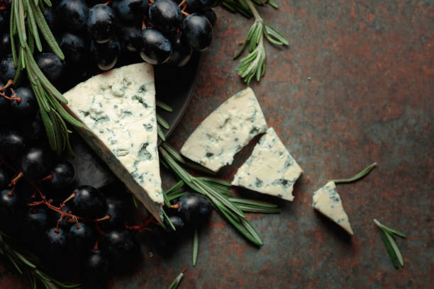 istock Blue cheese with grapes, and rosemary, on vintage background. 1349918821