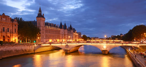The Pont au Change is a bridge over the Seine River with Conciergerie at background in Paris, France