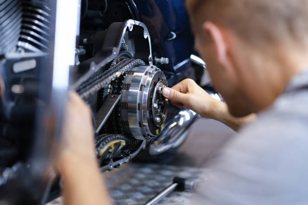 istock Mechanic repairs motorcycle engine in workshop closeup 1349921554
