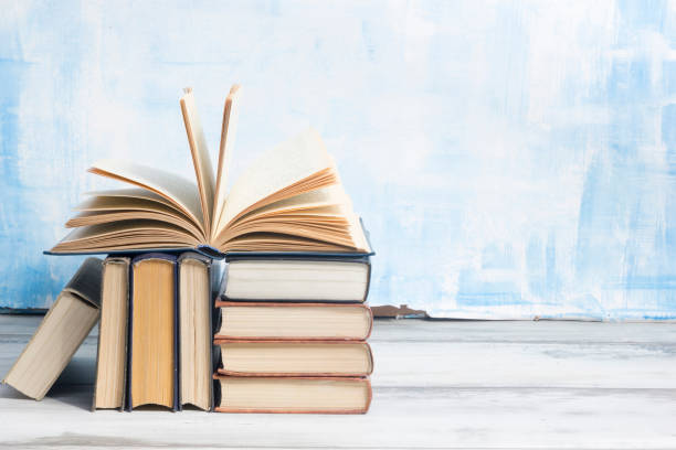 istock Open book, hardback books on wooden table. Back to school. Copy space. 1349921615