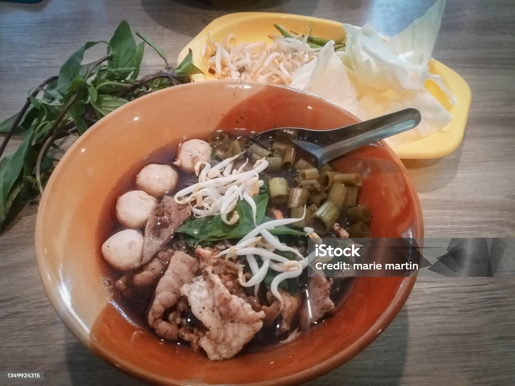 Guay Tiew Ruea (Boat Noodles) Guay Tiew Ruea (Boat Noodles)
refer to noodles with beef or pork in a thick brown broth which contains cinnamon, star anise and blood Asian Food Stock Photo