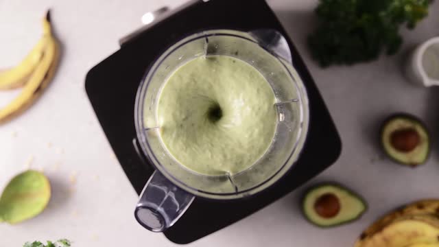 Banana and avocado smoothie blended in a blender