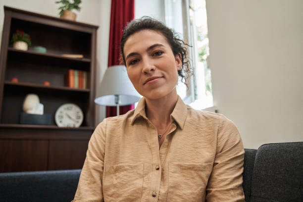istock Female therapist sitting at the sofa while consulting her patients 1349926255