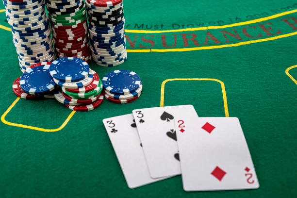 istock the cards are arranged next to colored chips that stand in columns on a green poker table 1349927916