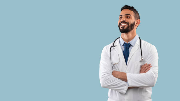 istock Happy Egyptian Physician Man Posing Near Copy Space, Blue Background 1349928022